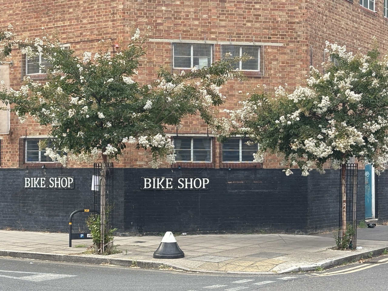 A photo of the facade of a brick building on a street corner